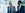 Two business men in an office foyer having a discussion