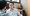 We are looking over the right shoulder of a man having a conversation with a man wearing glasses facing him in an office setting.