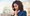 A young woman in a business suit having a troubling conversation on her mobile phone