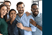Five work colleagues posing for a group photograph