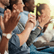 Close up a clapping hands belonging to seated people