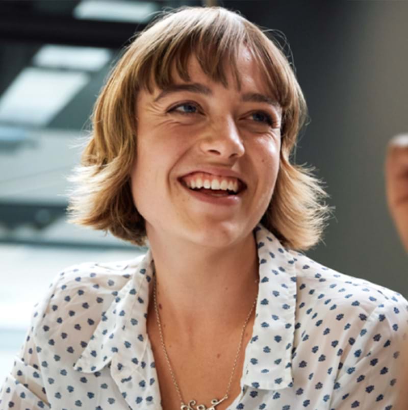 Two women looking at a computer screen and smiling