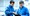 Two guys in blue fleece tops in a tech factory environment looking at an ipad